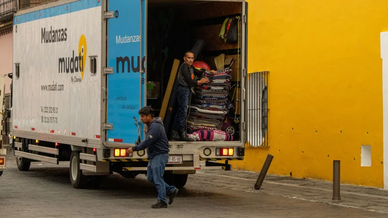 Un camion de déménagement ouvert, chargé de mobilier emballé